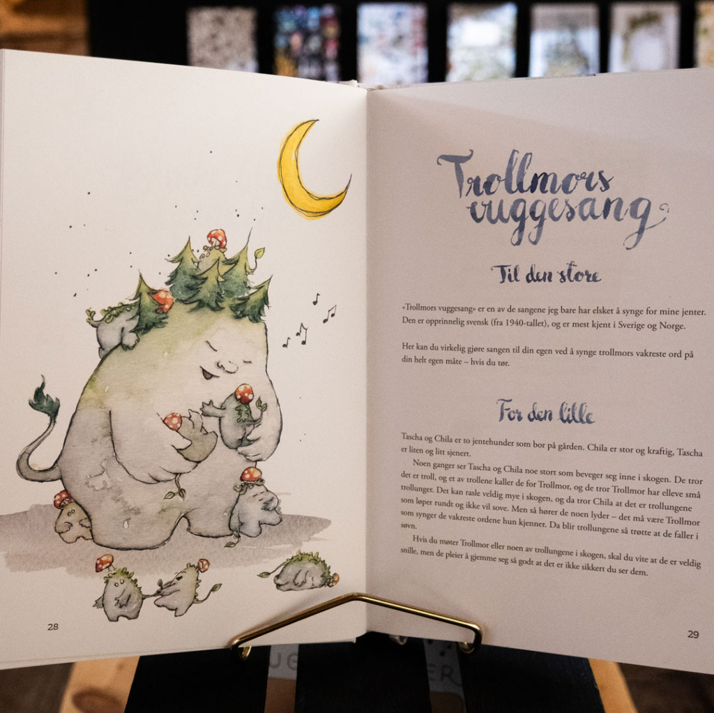 Spread from Sissel Kyrkjebø's lullaby songbook with the troll mother illustration
